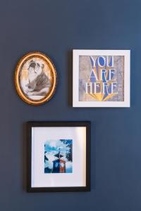 two framed pictures on a blue wall with paintings at The Hoya Hotel at Georgetown in Washington, D.C. +1 photo