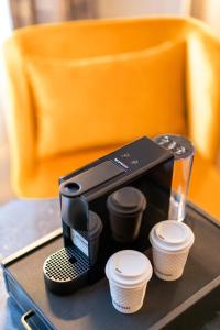 a coffee maker and some cups on a table at The Hoya Hotel at Georgetown in Washington, D.C.