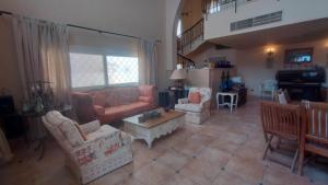 a living room with couches and chairs and a table at Hurghada Beach House in Hurghada