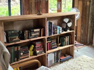 a wooden book shelf filled with books in a room at River Star Retreat in Zuurbraak