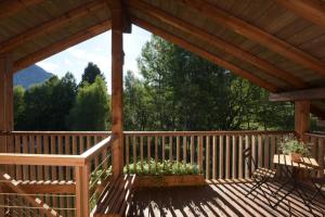 a wooden deck with a gazebo at B&B Mas de Lagorae in Tesero +32 photos