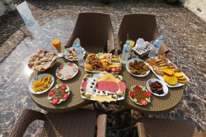 a table with plates of food on it at locanda pyramids view & Jacuzii in Cairo