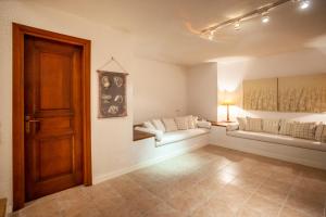 a room with a bed and a couch and a door at Magnolia bliss Calm & Cozy Villa, Sani in Sani Beach