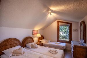 a hotel room with two beds with towels on them at Magnolia bliss Calm & Cozy Villa, Sani in Sani Beach