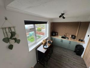 a kitchen with a table and a window at Victoria Park in Bristol