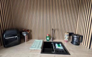 a kitchen counter with a sink in front of a wall at Victoria Park in Bristol