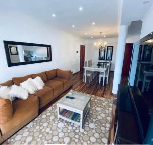 a living room with a brown couch and a table at Arborea in Posadas
