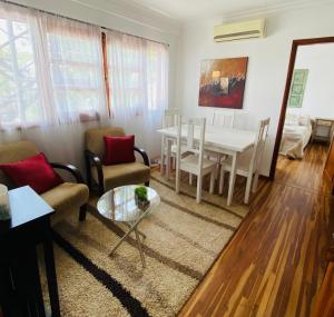a living room with a table and a dining room at Arborea in Posadas