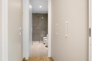 a white bathroom with a toilet and a shower at Bilo Cinema in Bonassola +22 photos