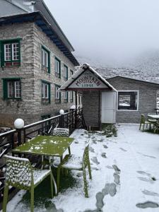a patio with a table and chairs in the snow at Hotel Mountain View - Namche in Namche