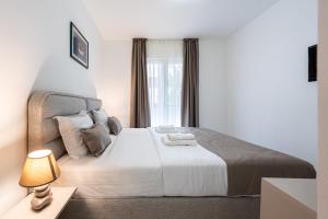 a bedroom with a large bed and a window at Hotel Podostrog - New Comfort 2026 in Budva