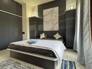 a bedroom with a large bed with black cabinets at Satgiri Nest House in Chikmagalūr