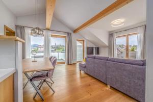 a living room with a couch and a table at Schmuckstück Ferienapartments Bodenmais inkl aktivCARD in Bodenmais