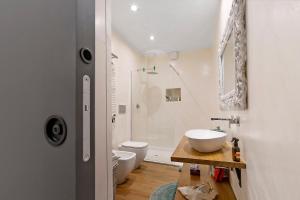 a bathroom with a sink and a toilet and a shower at Piazzetta della Torre in Chiavari +37 photos