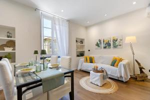 a living room with a white couch and a table at Piazzetta della Torre in Chiavari