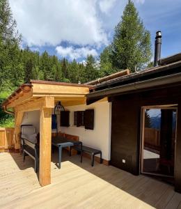 a pavilion with a table on a deck at Chalet Silentium in Bellwald