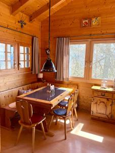 a dining room with a large wooden table and chairs at Chalet Silentium in Bellwald