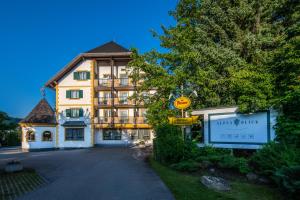 a large building with a sign in front of it at Hotel Alpenblick Kreischberg in Sankt Lorenzen ob Murau