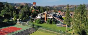 an aerial view of a house with a tennis court at VITALHOTEL Schulenberg in Schulenberg im Oberharz