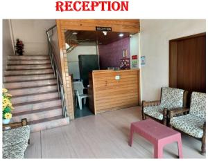 a room with two chairs and a table and stairs at Hotel Shreejay Lodging in Mahād