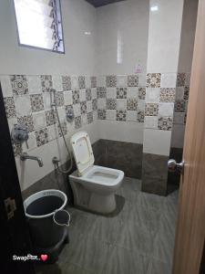 a bathroom with a toilet and a trash can at Hotel Shreejay Lodging in Mahād +23 photos