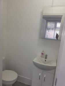 a bathroom with a sink and a toilet and a mirror at City view place, City Centre in Chesterton