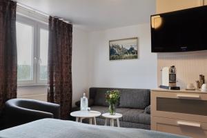 a living room with a couch and a table at VITALHOTEL Schulenberg in Schulenberg im Oberharz