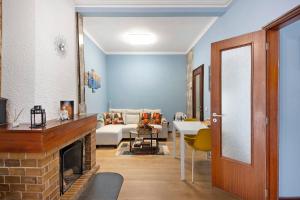 a living room with a couch and a fireplace at Casa da Ponte in Lombinha