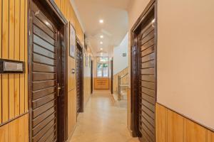 a hallway with wood paneled walls and a door at Treebo Holiday Hill in Dharmsāla