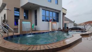 ein Swimmingpool vor einem Haus in der Unterkunft The Bubbles Hotel in Akobo