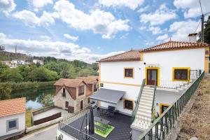 arial view of a house with a balcony at Casa da Ponte in Lombinha