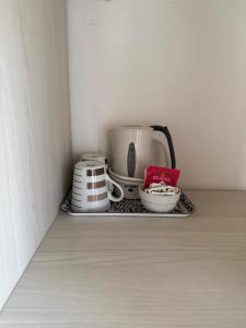 a shelf with a tea pot and cups on it at Sugadoi in Predazzo +3 photos
