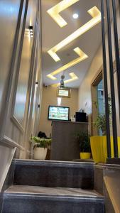 a lobby with a waiting area with potted plants at Moon Stays Newly Build I Couple Friendly I Panipat in Pānīpat