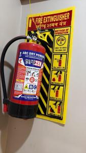a fire extinguisher is attached to a fire extinguisher sign at Moon Stays Newly Build I Couple Friendly I Panipat in Pānīpat
