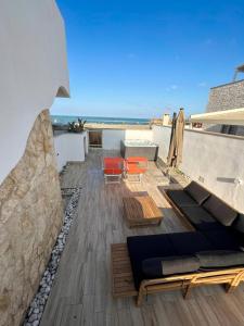 a rooftop patio with a view of the ocean at Fiorucci Apartments - Veronica's House Fiumicino in Focene