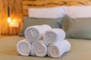 a pile of towels sitting on top of a bed at Terra Nova Penthouse in Lajita +13 photos
