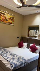a bedroom with a bed with red pillows on it at Moon Stays Newly Build I Couple Friendly I Panipat in Pānīpat
