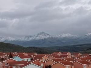 a group of houses with snow capped mountains in the background at Mayors Rest on 44 in Uniondale +2 photos