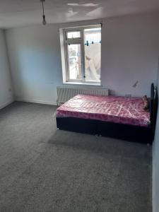 a bedroom with a bed in a room with a window at OGb in Bolton