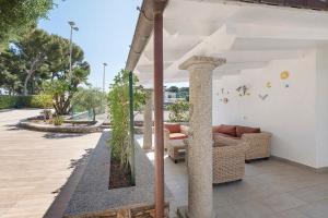a patio with a couch and chairs on a building at Villetta Antonia in Marina di Andora