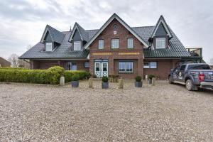 a house with a car parked in front of it at Pure Relaxation in Heiligenhafen