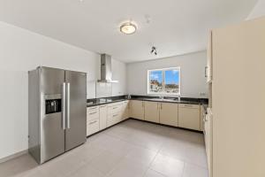 a kitchen with stainless steel appliances and a window at Blue Horizon Penthouse in Dorp Sint Michiel