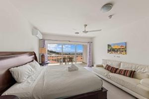 a living room with a bed and a couch at Blue Horizon Penthouse in Dorp Sint Michiel