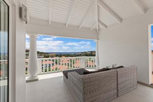 a living room with a couch and a large window at Blue Horizon Penthouse in Dorp Sint Michiel +24 photos