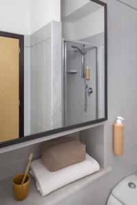 a bathroom with a shower and a mirror at Hotel Al Sant'Andrea in Sarzana