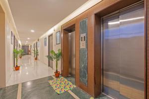 a hallway with a rug on the floor in a building at Treebo GT Meridian, T-Nagar in Chennai