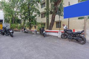 a group of motorcycles parked in front of a building at Treebo GT Meridian, T-Nagar in Chennai +26 photos