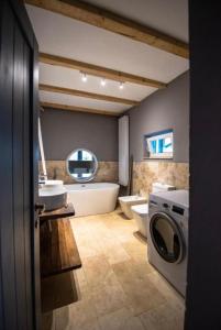 a bathroom with a toilet sink and a washing machine at Guesthouse340 in Roman