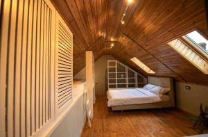 a bedroom with a bed in a wooden ceiling at Guesthouse340 in Roman