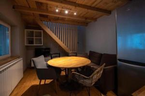 a room with a table and chairs and a couch at Guesthouse340 in Roman